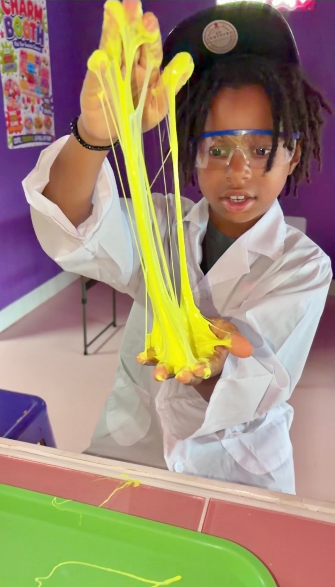 Hands stretching glitter slime